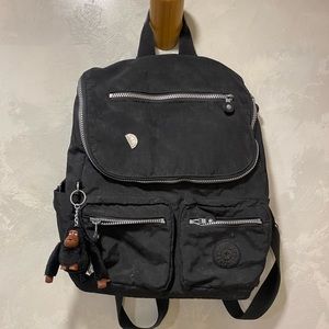 Black Kipling backpack with laptop compartment and two front pockets